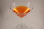 orange-pink Comtesee d'Italia cocktail on white background