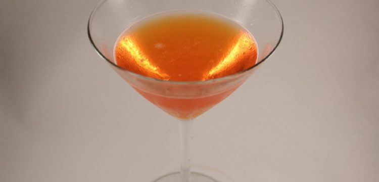 orange-pink Comtesee d'Italia cocktail on white background