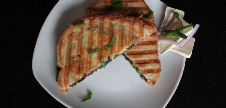 Completed bacon brie panini on plate