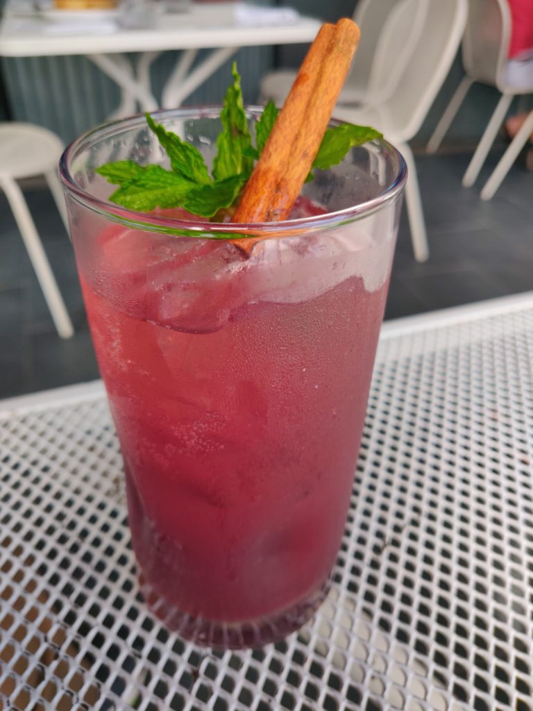 Give it a Chai Mocktail with cinnamon stick and mint garnish on a table outside