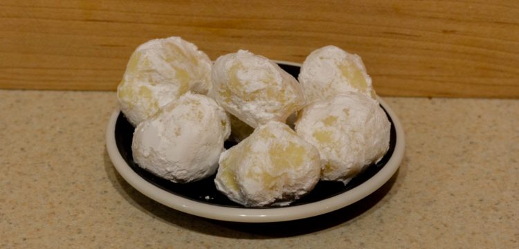Several white chocolate lemon truffles on a small plate