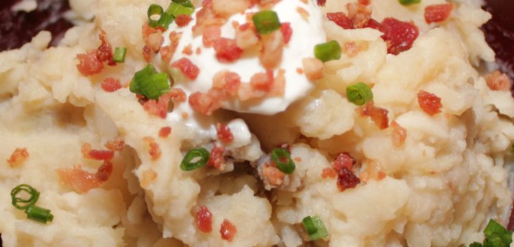 The best Slow Cooker Garlic Mashed Potatoes! Potatoes melt into broth and butter, then topped with bacon and chives | BearandBugEats.com