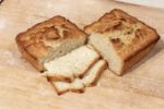 Two halves of beer bread loaf posed with two slices